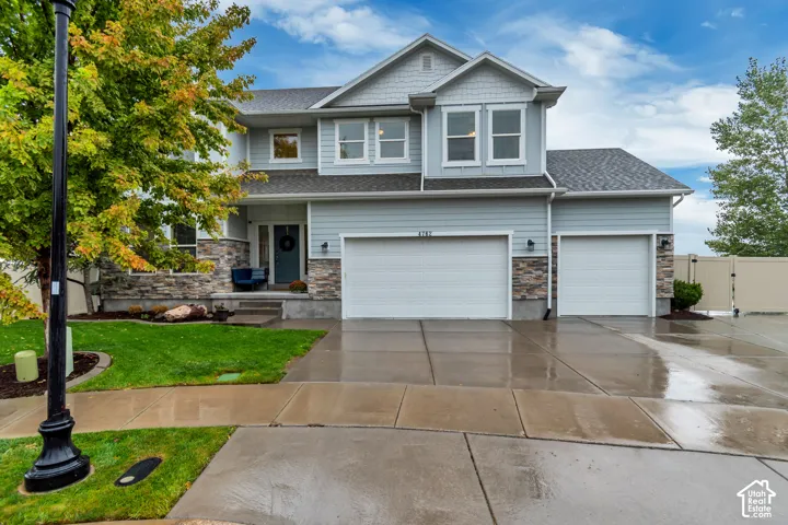 Contemporary two-story exterior with light blue siding and stone accents