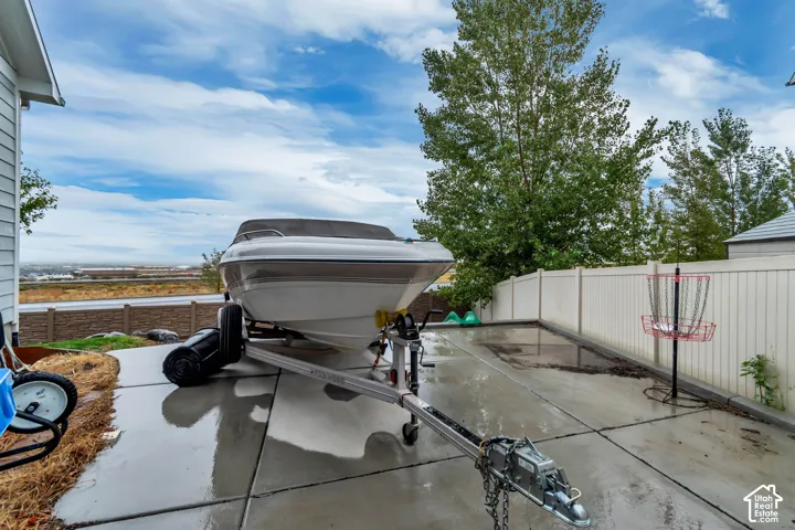 Paved side yard with a privacy fence