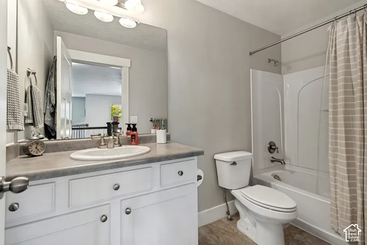 White vanity with brushed nickel hardware, oval undermount sink, and a single-handle faucet