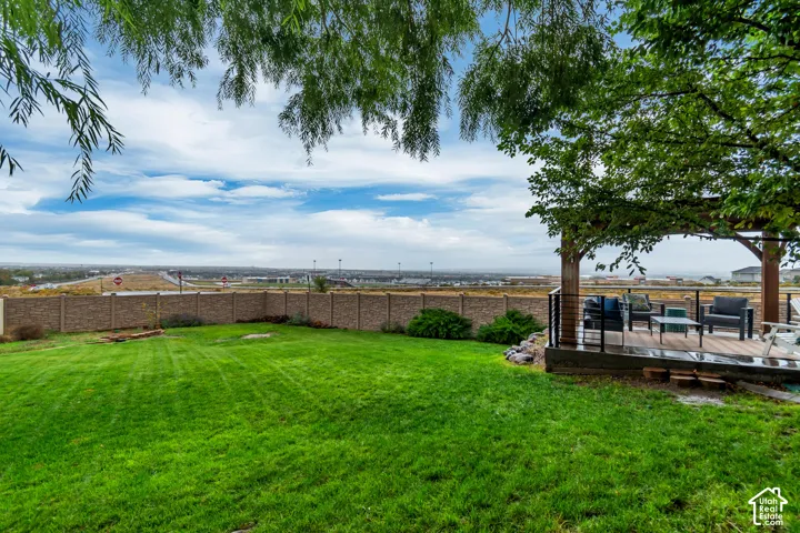 Expansive green lawn with a privacy fence