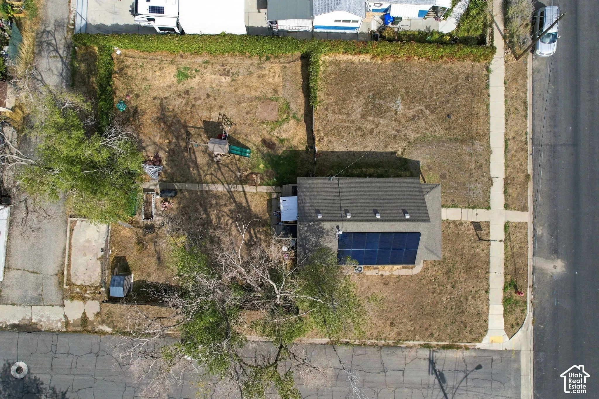 Single-story residence with a dark shingle roof, equipped with solar panels
