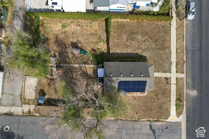 Single-story residence with a dark shingle roof, equipped with solar panels