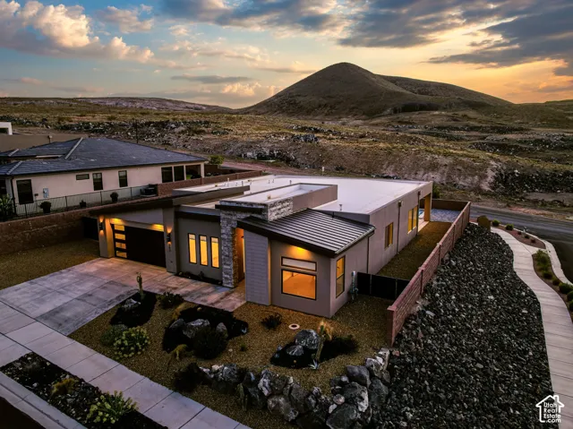 Modern exterior with varied rooflines, stone accents, and an attached garage