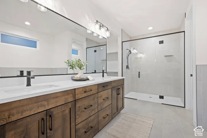 Double vanity with wood-finish cabinetry and matte black hardware