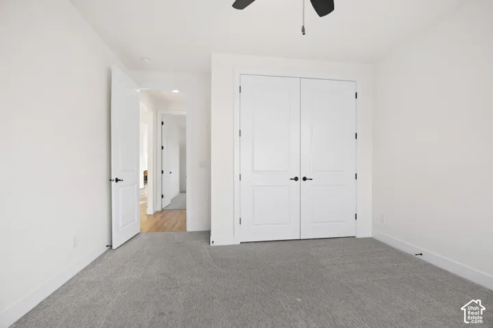 Light grey carpeting with white trim and white walls