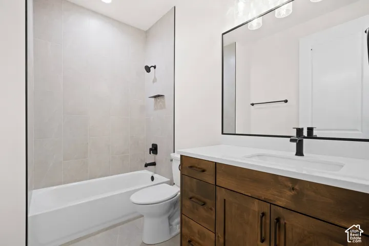Hardwood vanity with a light countertop and undermount sink