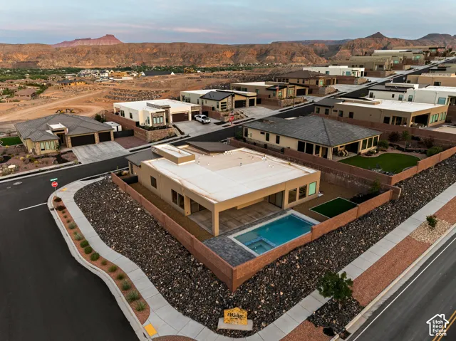 Contemporary exterior with a flat roofline, private swimming pool, and integrated spa