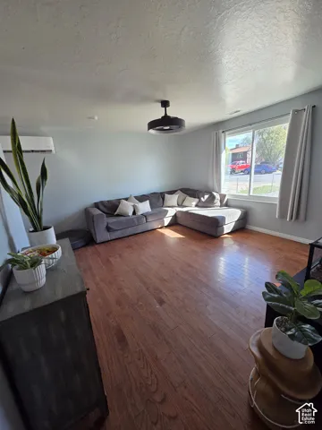 Hardwood-finish flooring, recessed lighting, and a ceiling fan with integrated lighting