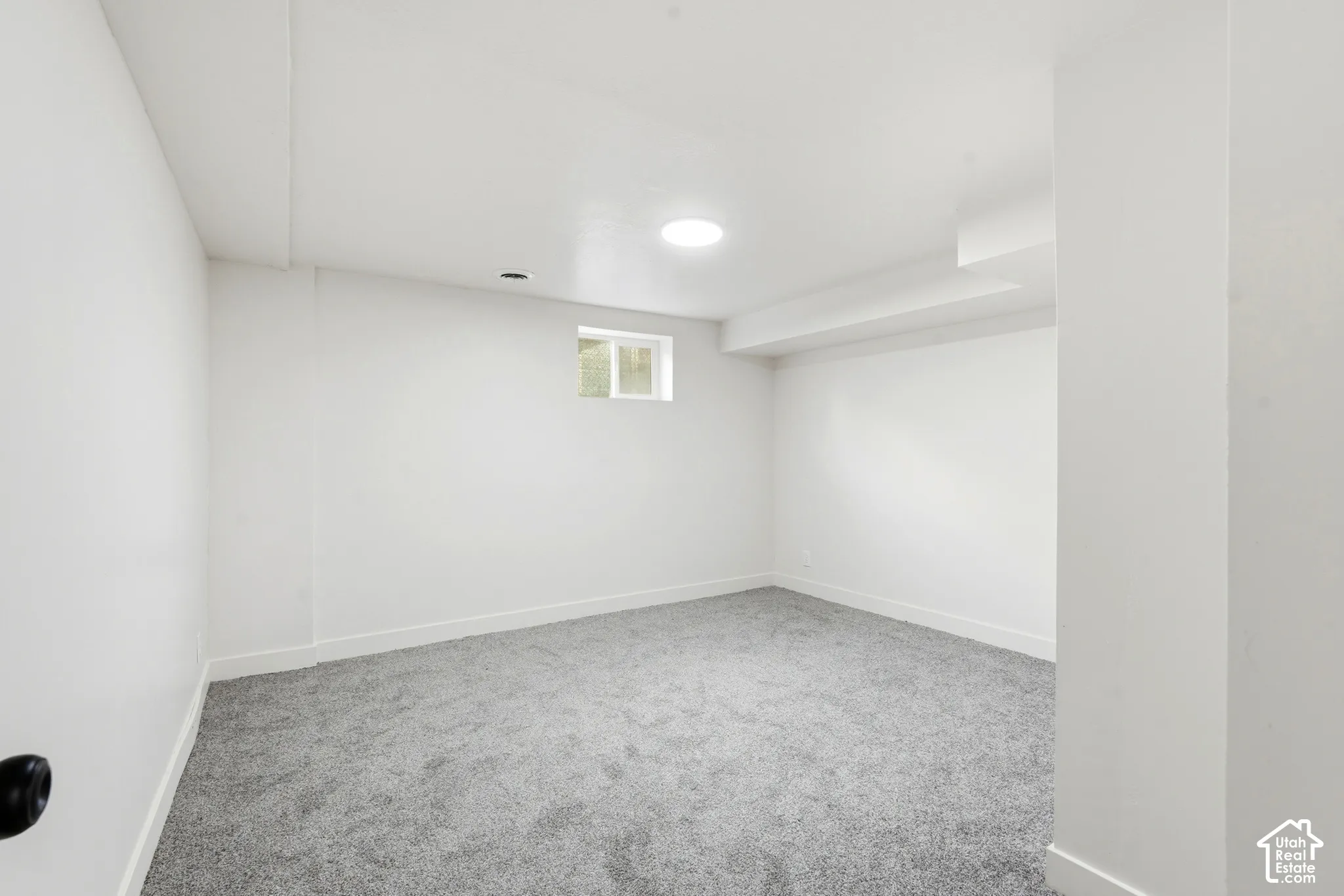 Neutral wall finishes, recessed lighting, and grey carpet flooring