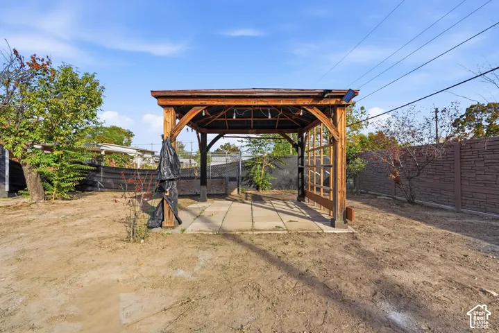 Wood-frame pergola with string lighting over a paver patio