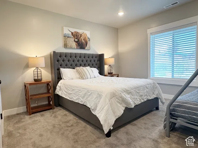 Neutral wall paint, recessed lighting, and carpeted flooring