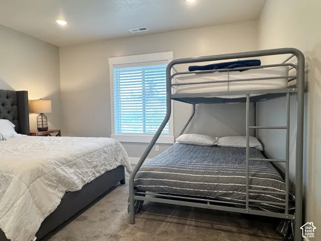 Recessed ceiling lighting, window with blinds, and neutral wall tones