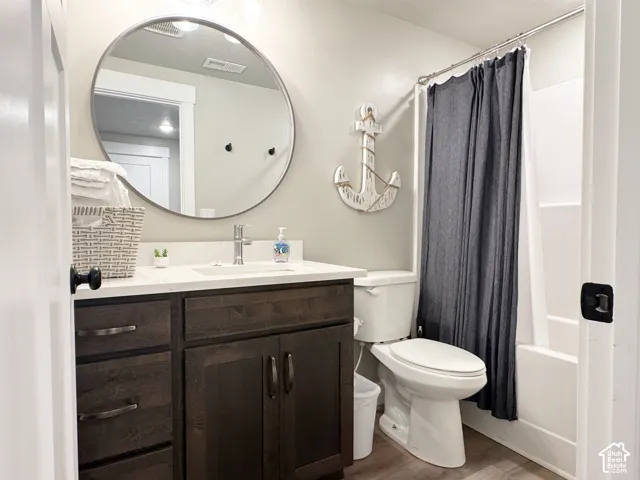 Bathroom featuring a vanity with dark wood-finish cabinetry, a white countertop, and an undermount sink