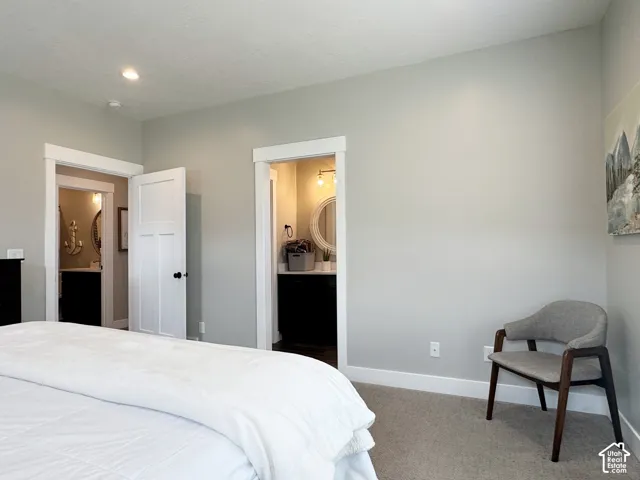 Neutral wall paint and carpeting, recessed lighting, and white trim