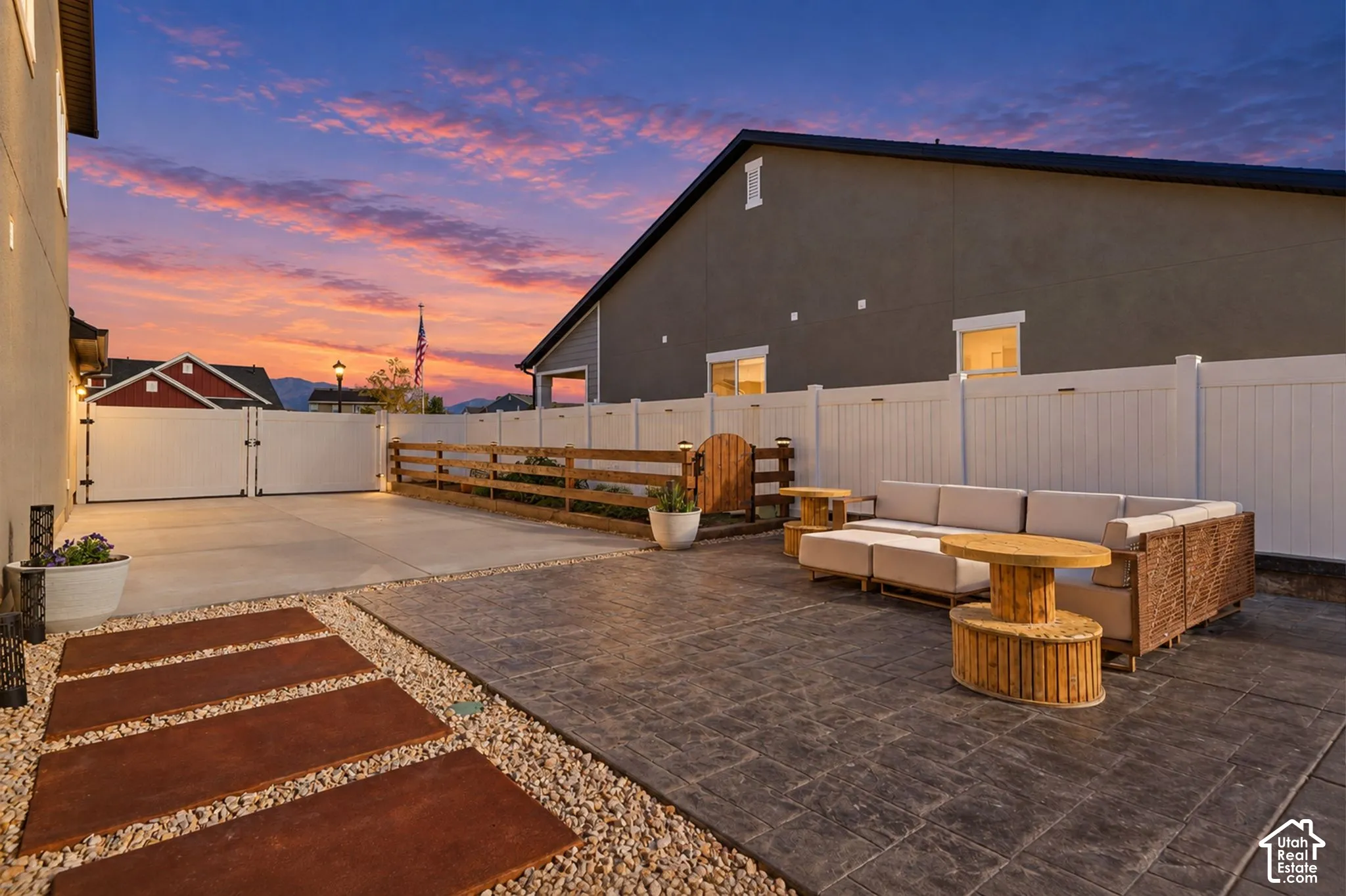 Stamped concrete patio with a gravel pathway and rectangular pavers