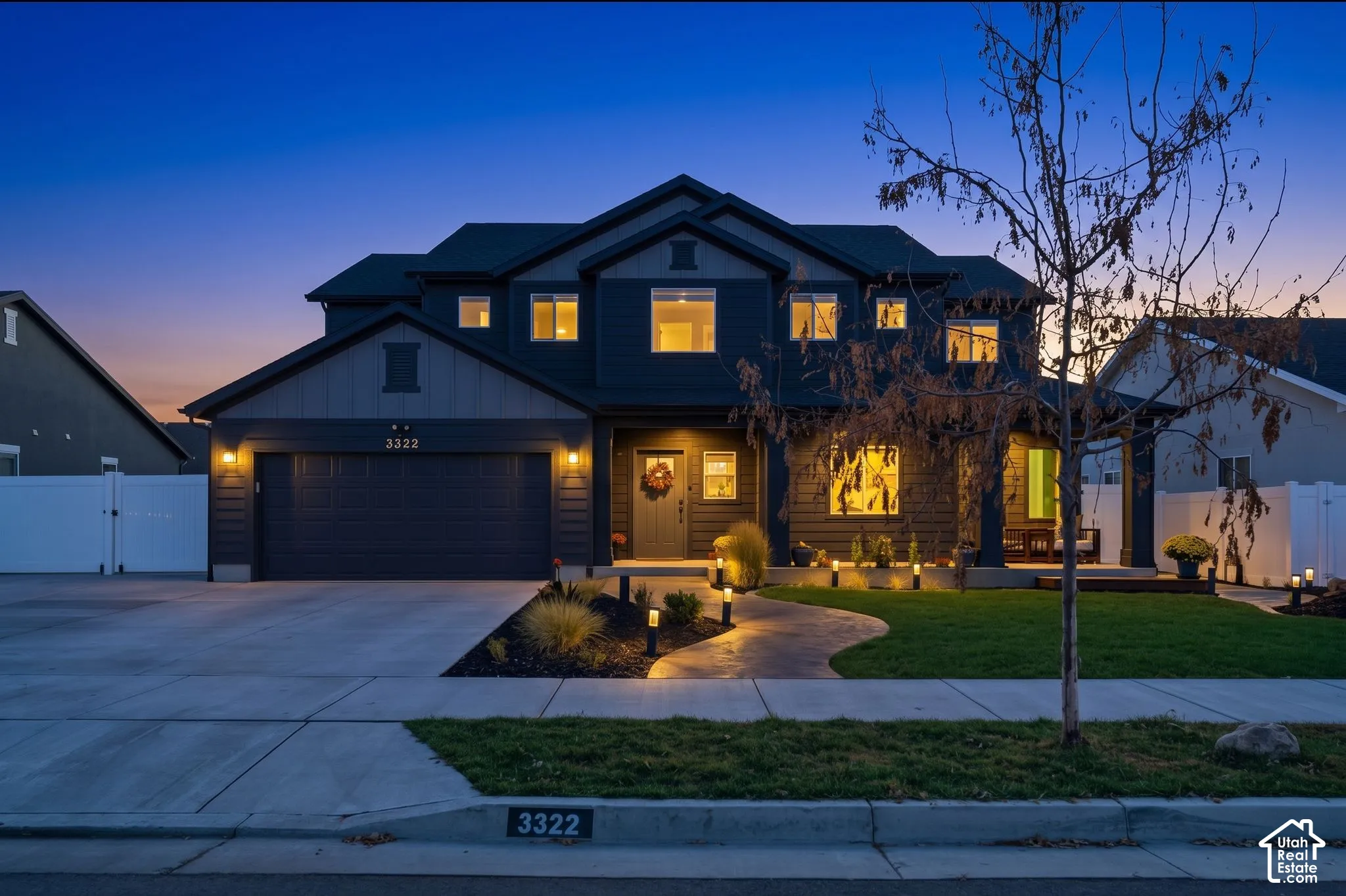 Contemporary two-story exterior with dark siding and stone accents