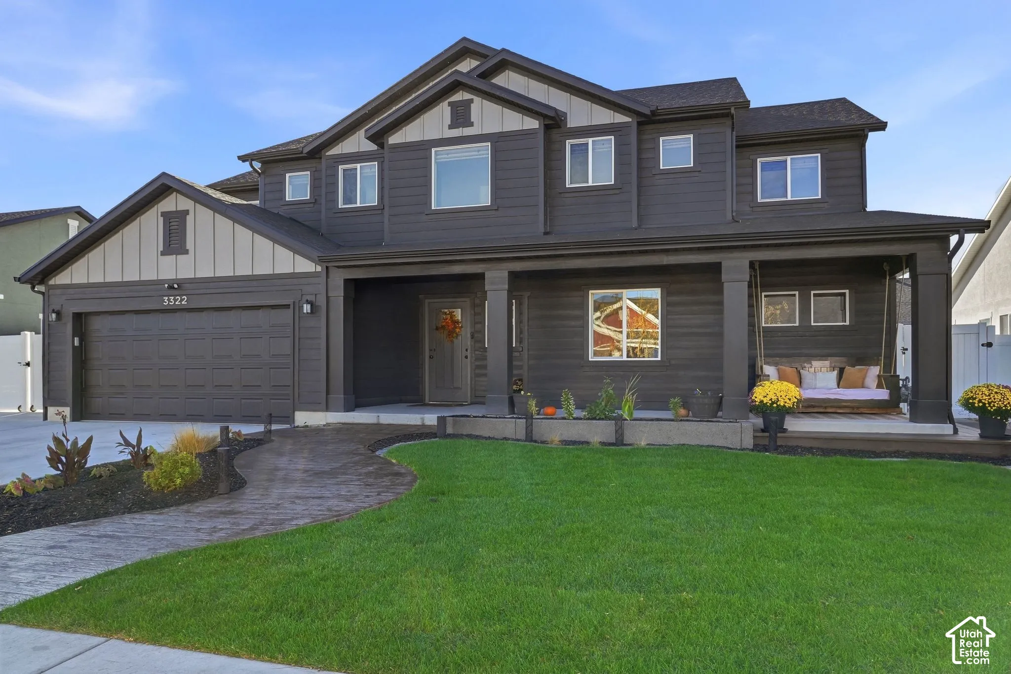 Modern two-story residence with a dark exterior and light-colored trim accents