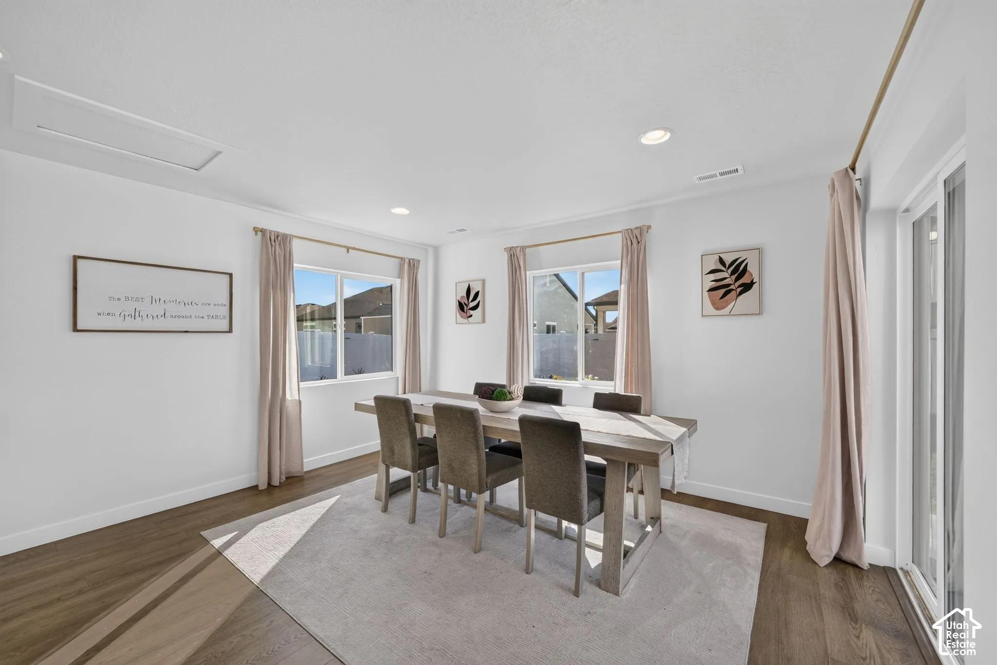Room featuring wood-finish flooring, recessed lighting, crown molding, and a sliding glass door