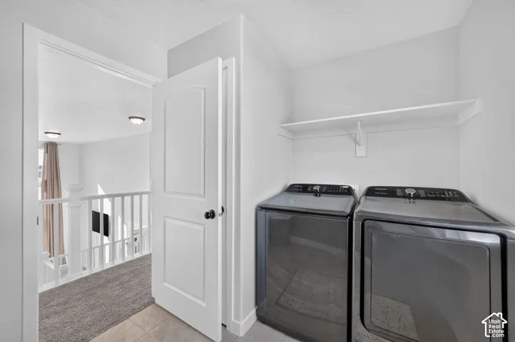 Dedicated laundry area featuring a wall-mounted shelf and tile flooring