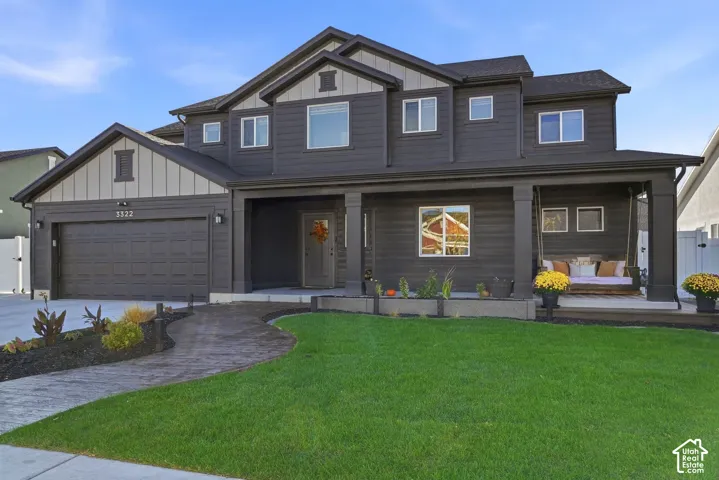 Modern two-story residence with a dark exterior and light-colored trim accents