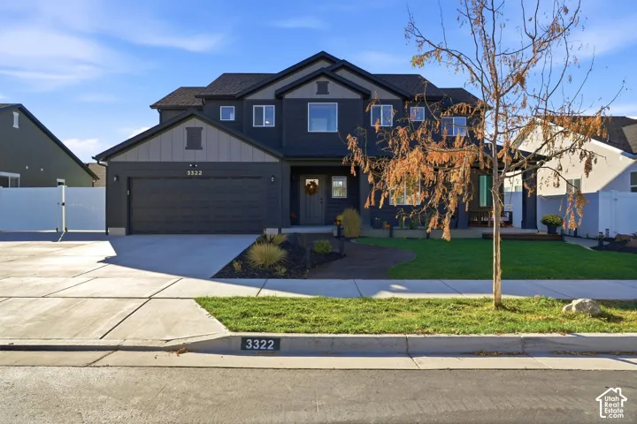 Two-story home with dark siding and light gray accents