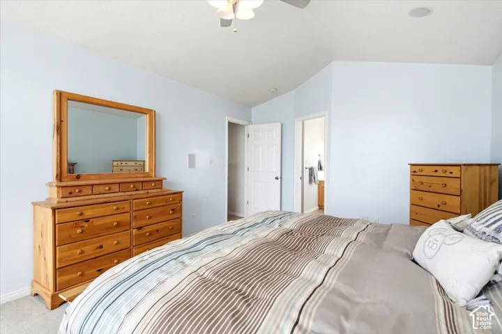 Angled ceiling lines with recessed lighting, ceiling fan, and light blue wall finish