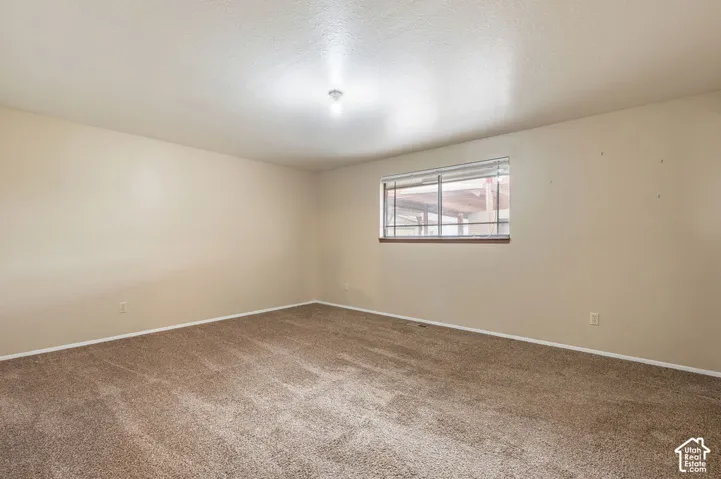 Neutral-toned walls complement the textured carpeting