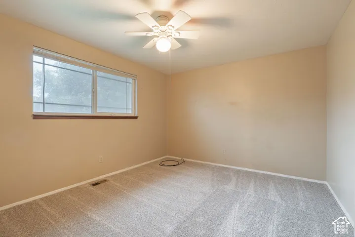 Neutral-toned walls complement the light-colored carpet flooring
