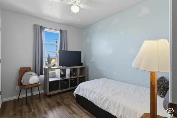 Wood-finish flooring with light blue wall accent and white wall paint