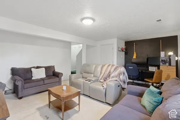 Recessed lighting fixture, light-colored carpeting, white interior doors, and a built-in alcove