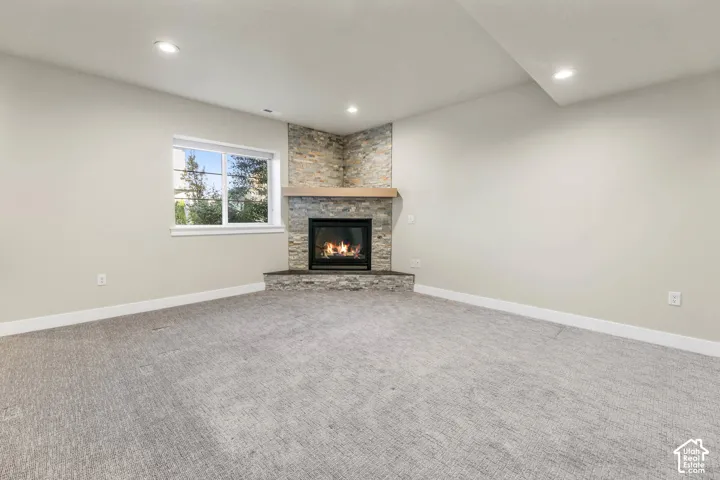 Corner fireplace with stone surround and wood mantel