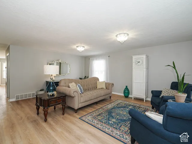 New neutral wall paint featuring new LVP wood-finish flooring, and custom wood blinds.