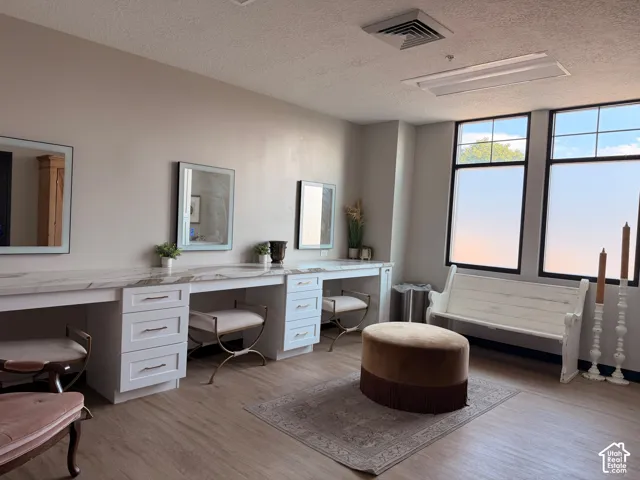 Bride room - Built-in vanity stations with white cabinetry and light-colored countertops