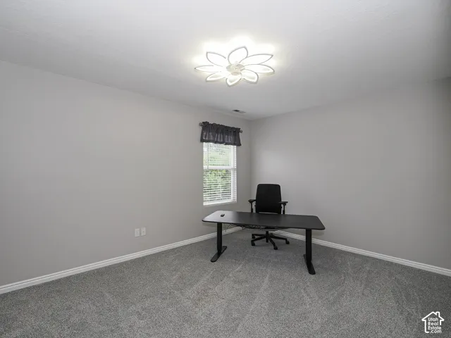 Bedroom 4 with new carpet, custom wood blinds, and new ceiling fan/light fixture.