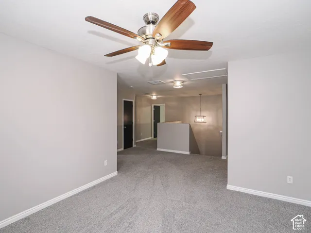 Large loft/potential bedroom 5 with new carpet, new paint, and Hunter ceiling fan.