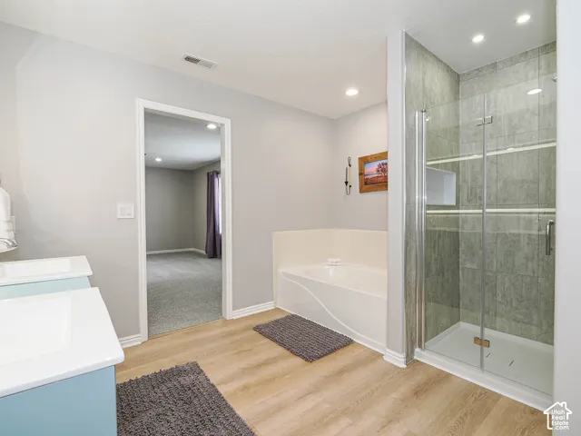 Master Bathroom with new double vanity, large soaking tub, new shower with tile and euro glass door, with new matching chrome fixtures.