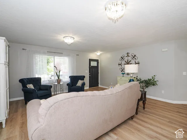 Living room with large window and custom front door, with leaded glass insert.