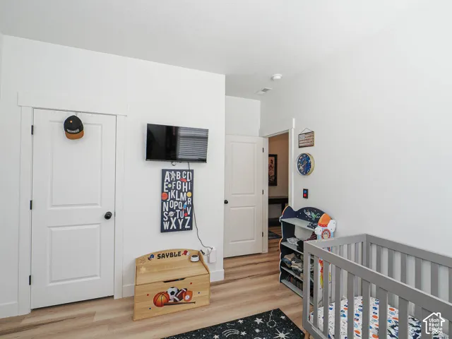 White walls, wood-finish flooring, and white trim