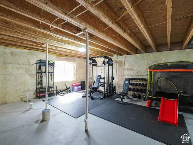 Concrete slab flooring with exposed ceiling joists and support columns