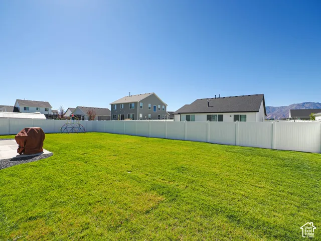 Expansive lawn with a white vinyl fence