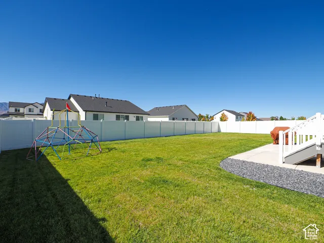 Expansive grassy yard with full vinyl fencing