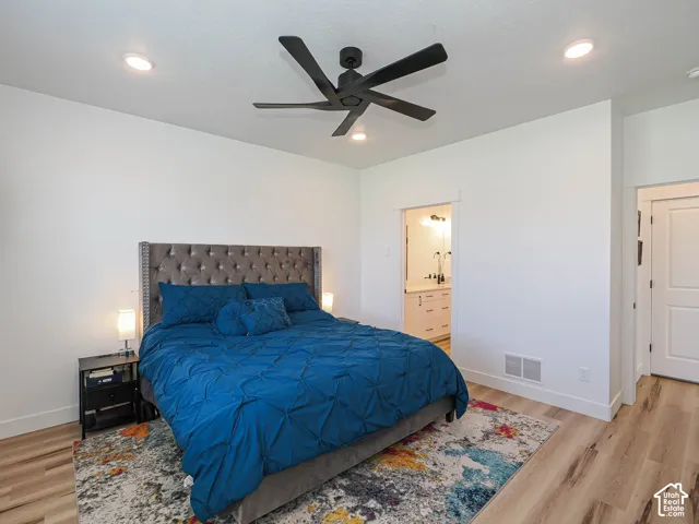 Recessed lighting, ceiling fan, wood-finish flooring, white trim, and a white interior door