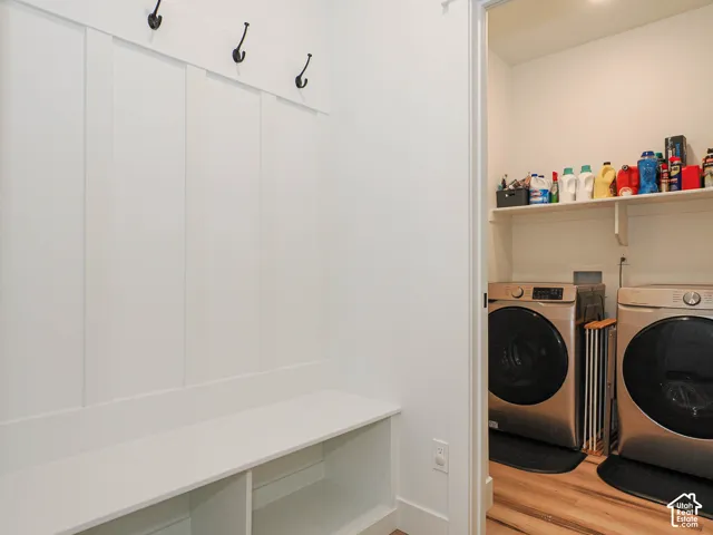 Built-in hall tree with integrated bench seating, storage cubbies, and dark-finished coat hooks