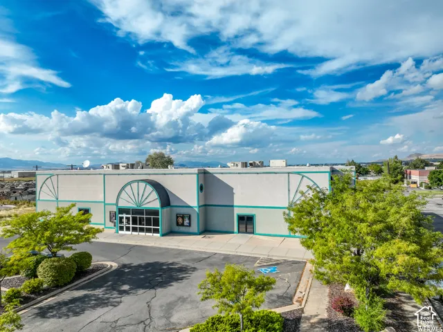 Commercial structure with a light-colored facade and teal accents