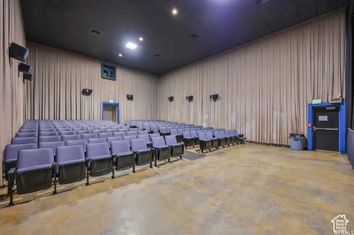 Auditorium seating with multiple rows, durable flooring, and acoustic wall treatments