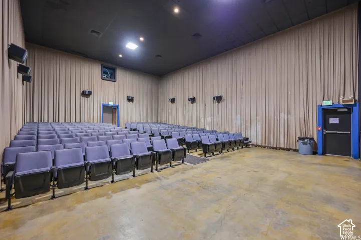 Auditorium seating with multiple rows, acoustical wall treatments, and recessed ceiling lighting