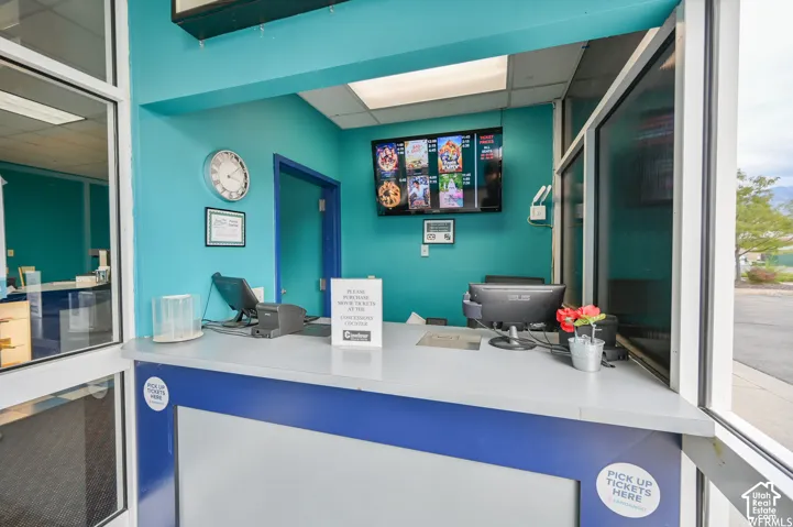Counter with blue and white accents, built-in display screen, and exterior window opening