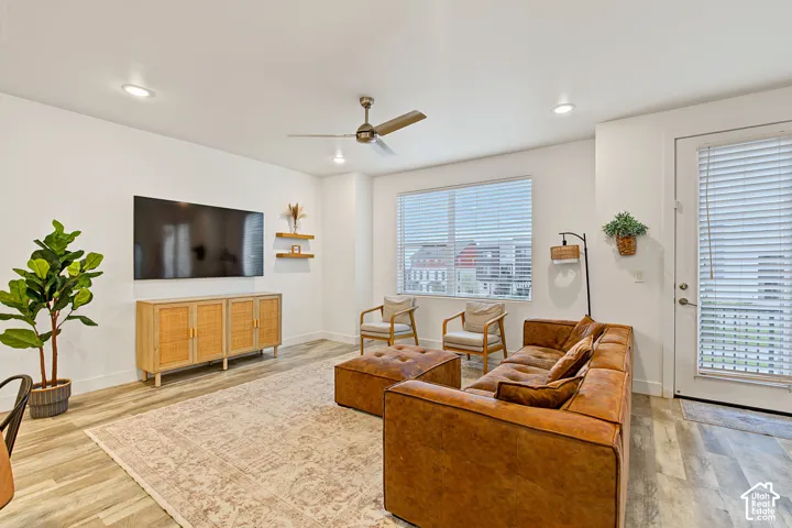 Living area featuring wood-finish flooring, recessed lighting, and a ceiling fan