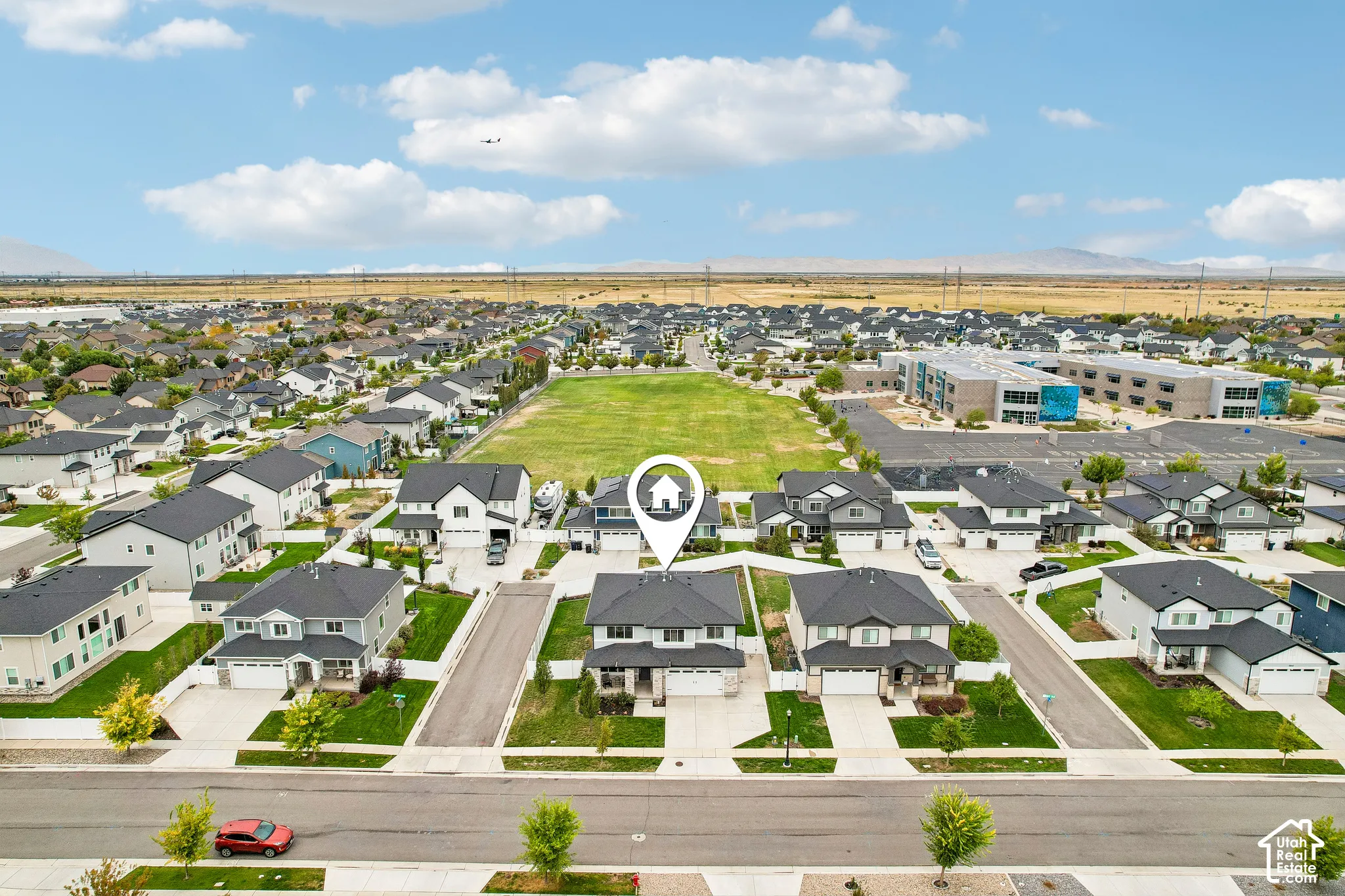 Aerial perspective showcasing a residential development with a prominent green space