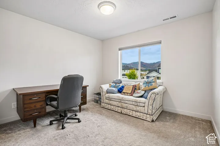 Neutral wall paint, recessed lighting, and carpeted flooring